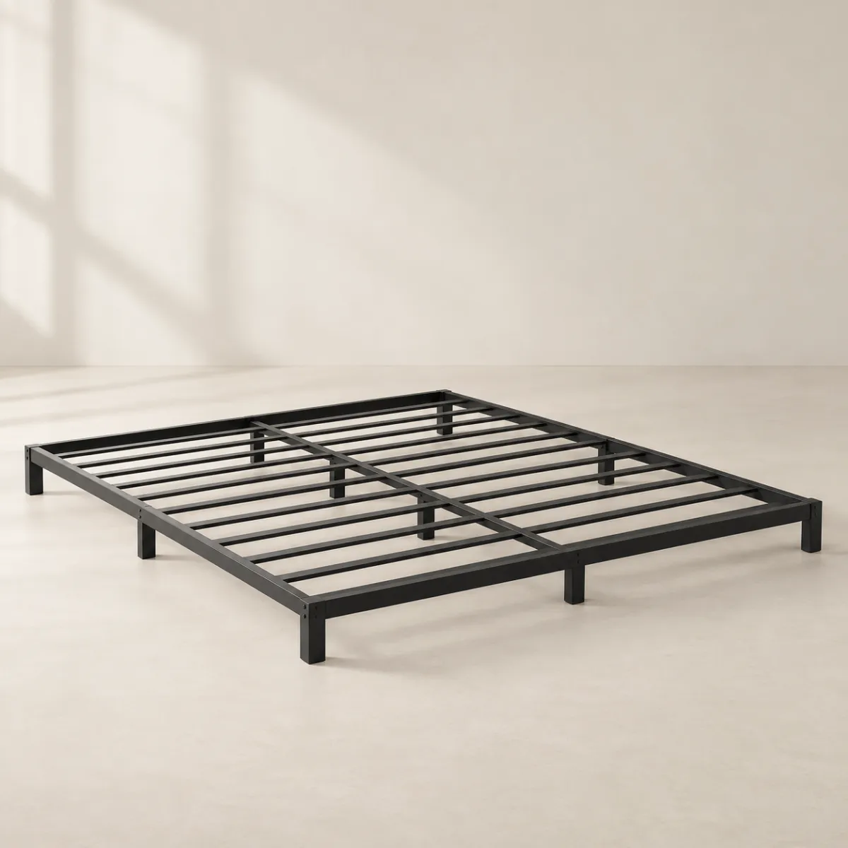 Low-profile black metal queen bed frame for a box spring